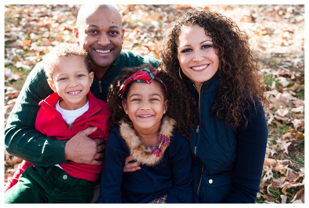 family sitting in leaves