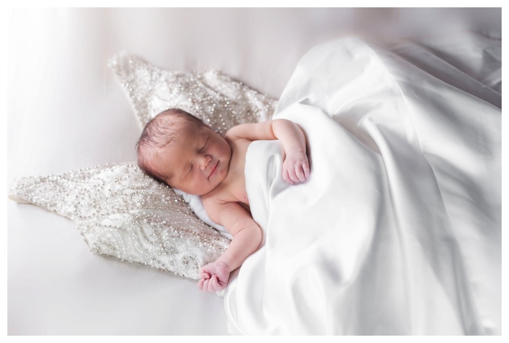 newborn girl on moms wedding dress