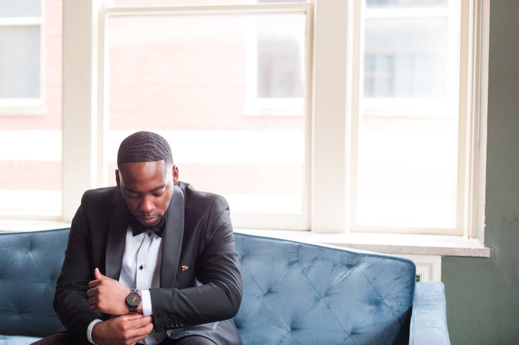 groom sitting on couch