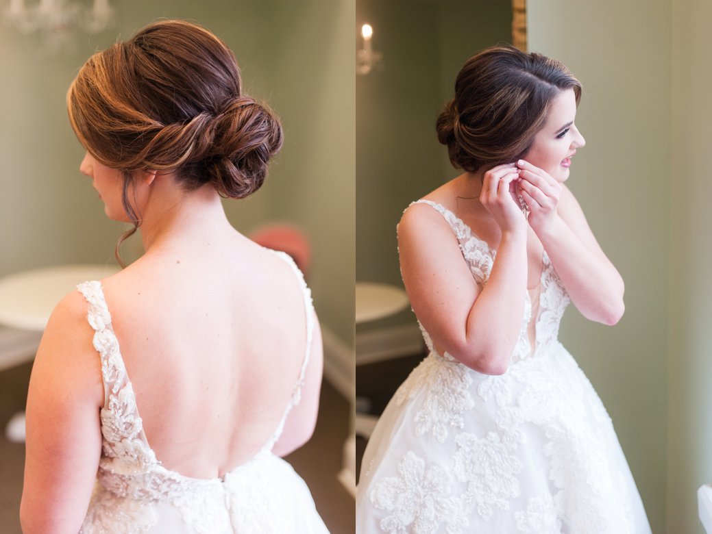 bride with updo putting in earrings