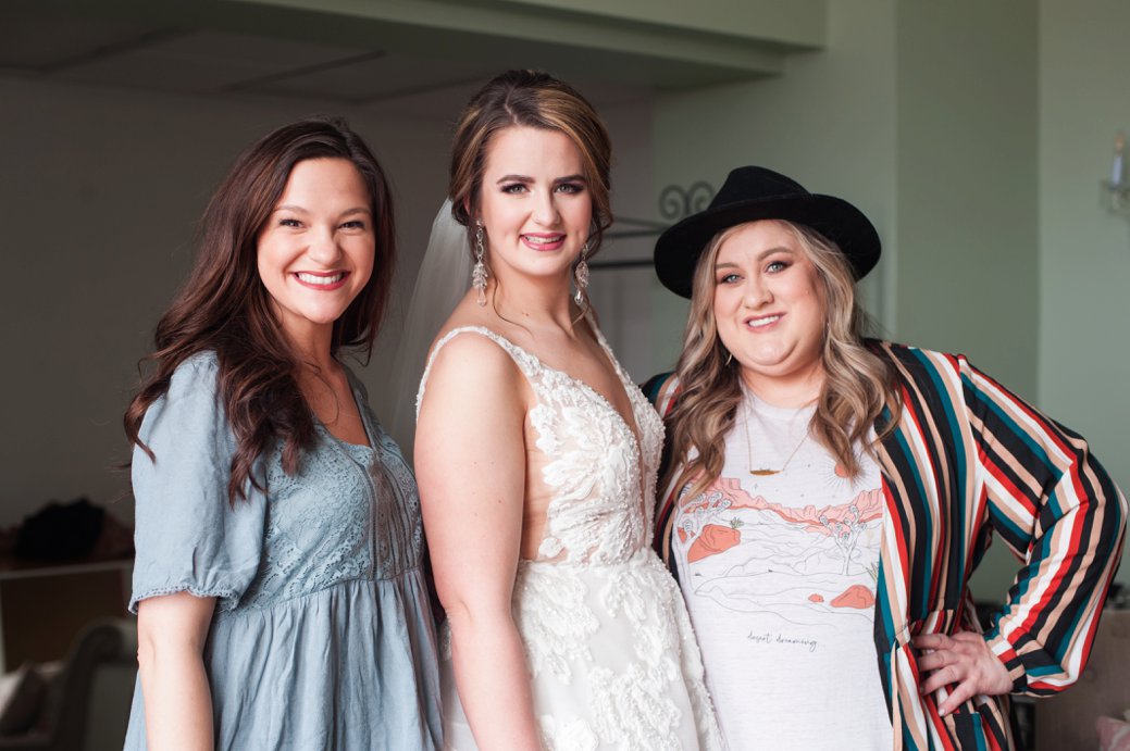 bride with her hair and makeup team