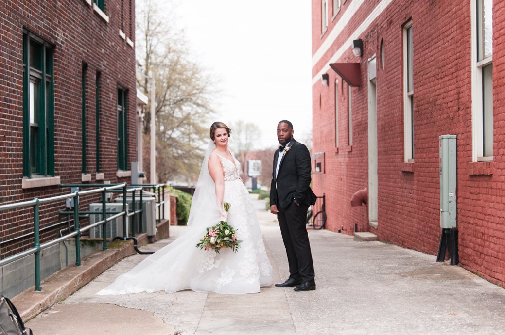 bride and groom in alley