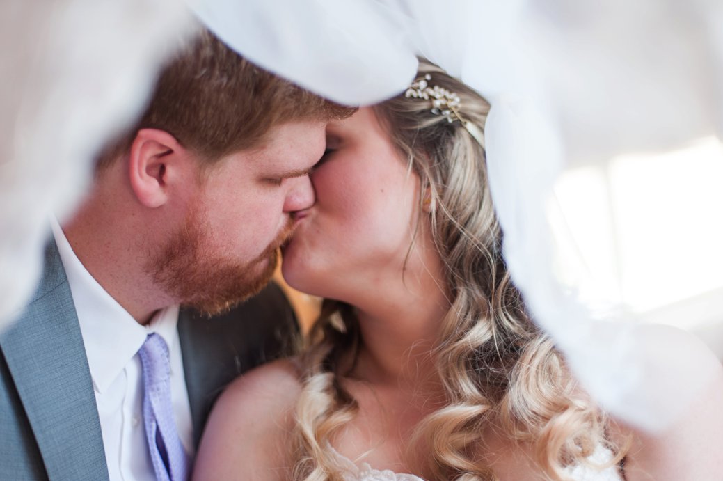 Blessings Barn bride kissing under veil