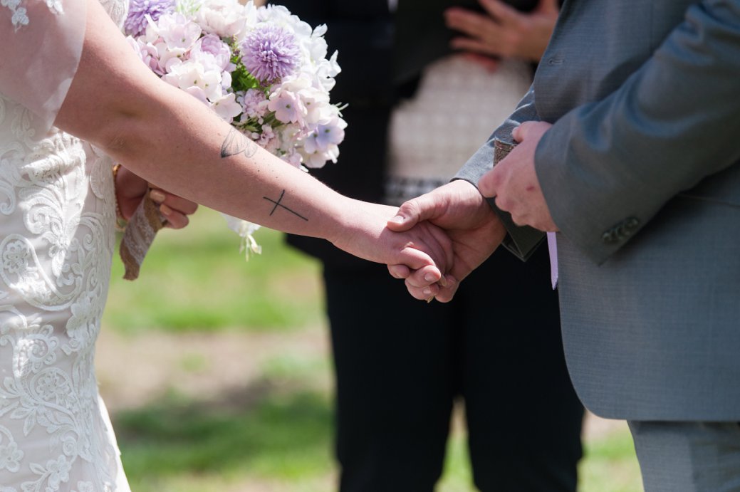 bride and groom holding hands