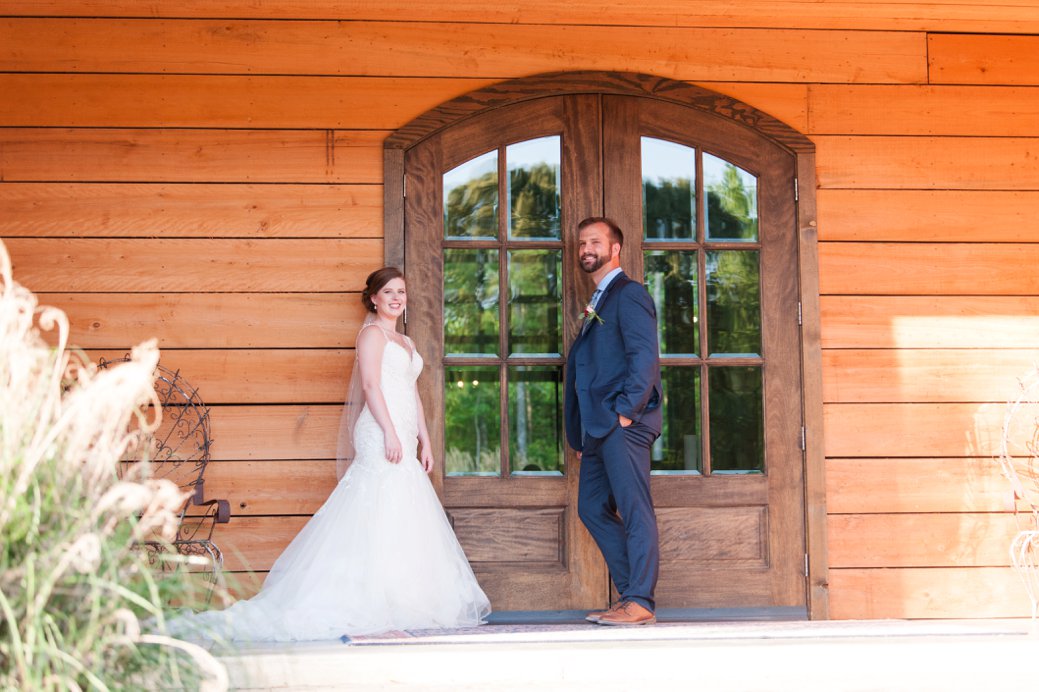 K & M Barn couple in front of front door