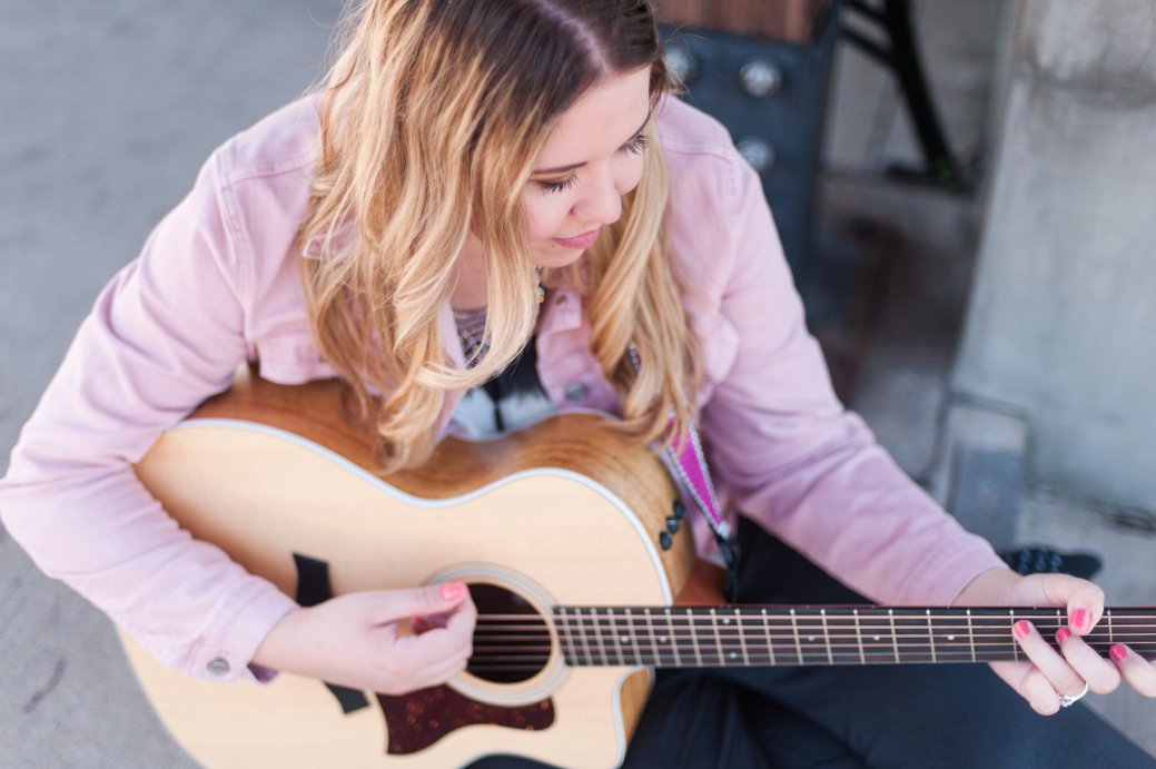 Macy Krew with guitar