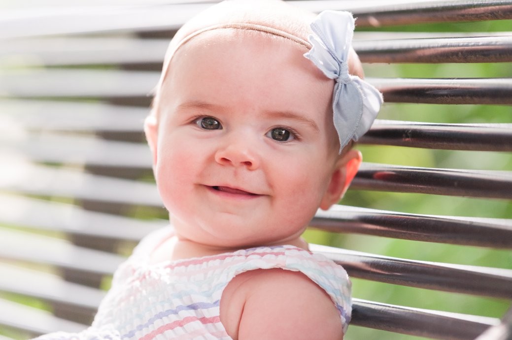 baby girl on bench