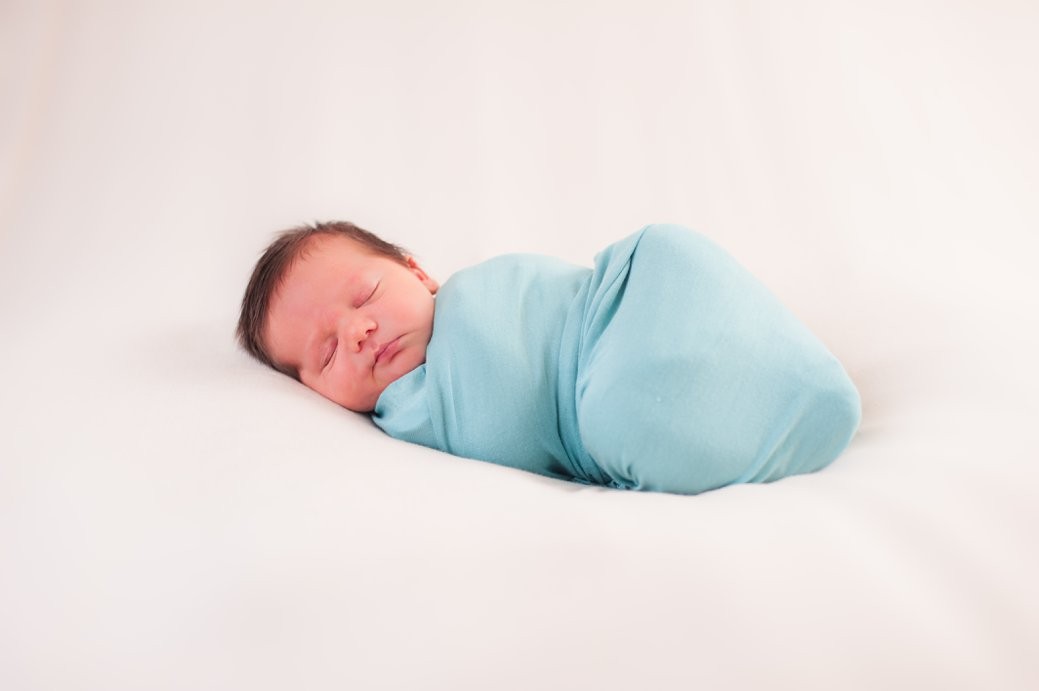 mcintyre newborn session baby in blue swaddle