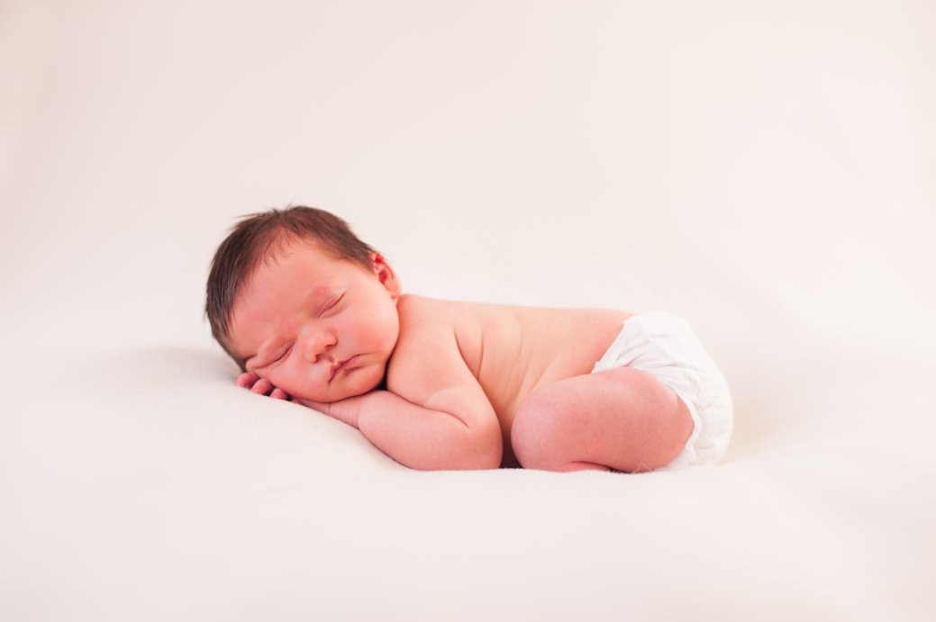 baby on white background in diaper