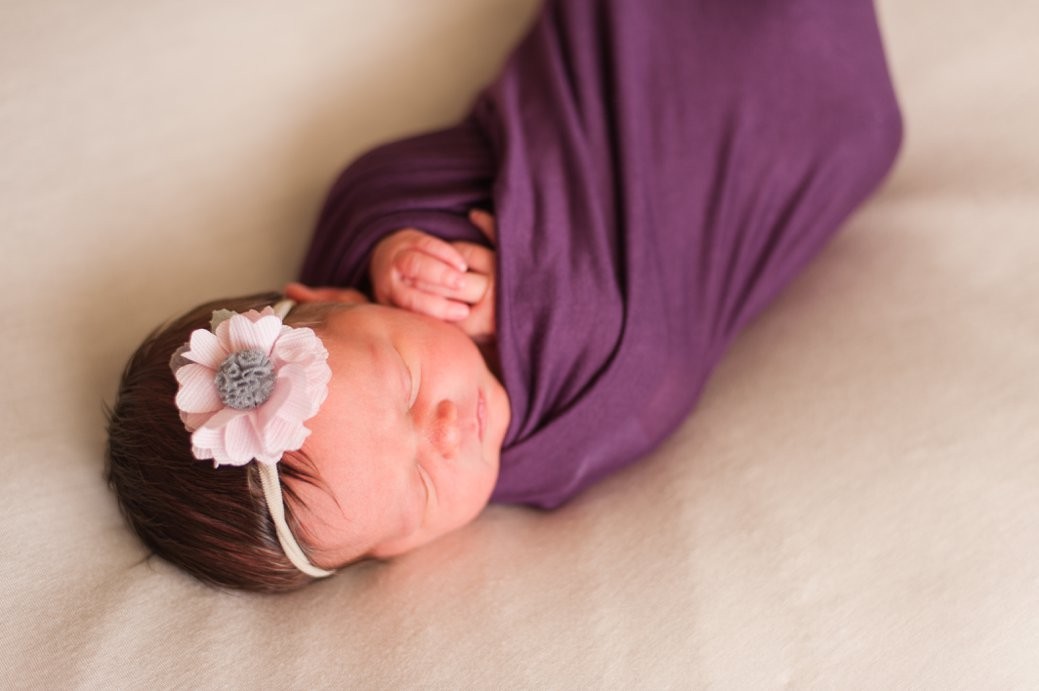 baby in purple wrap with bow