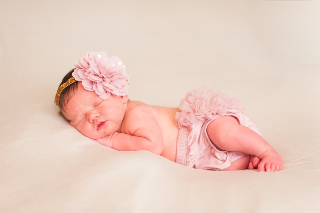 baby laying on side in pink