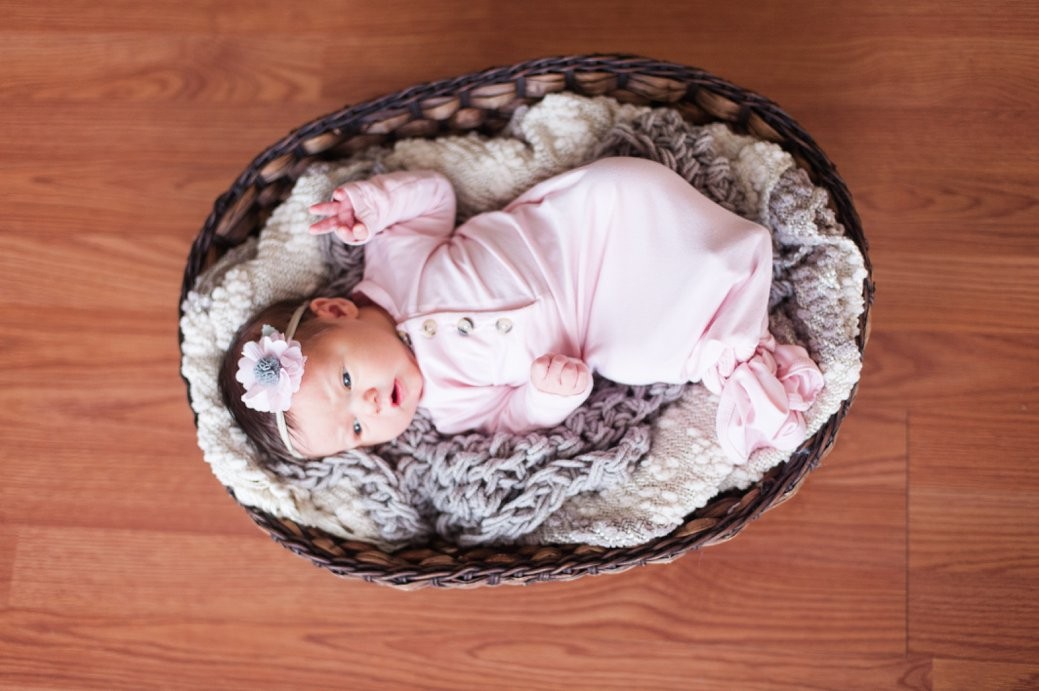 newborn in pink in basket