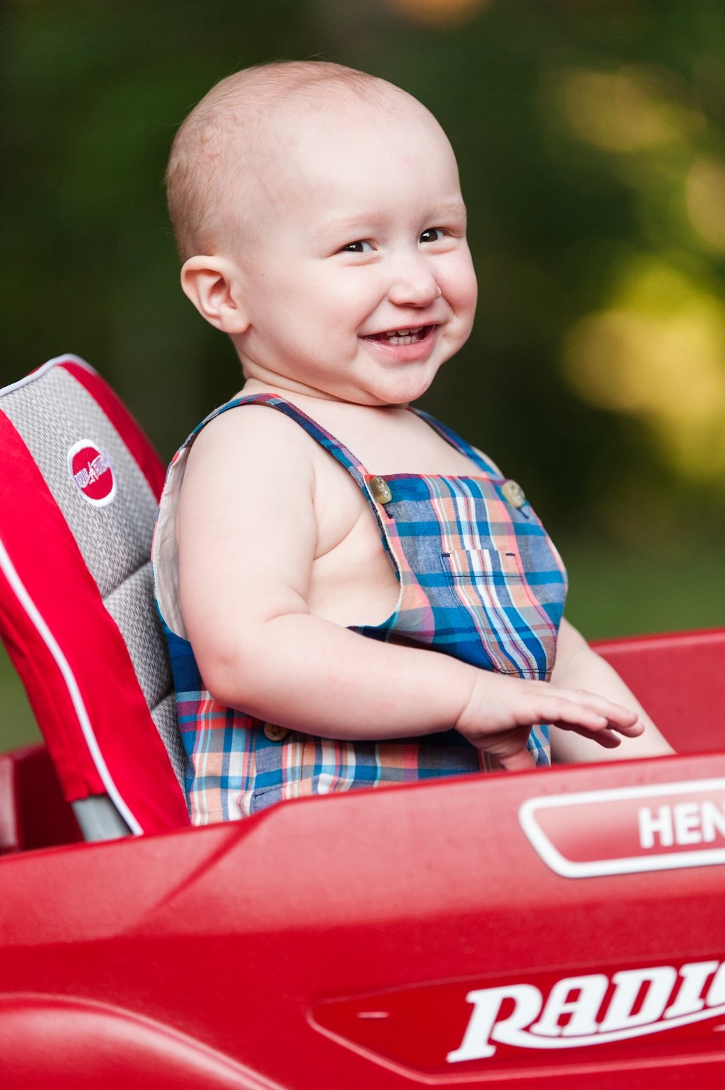 laughing boy in wagon