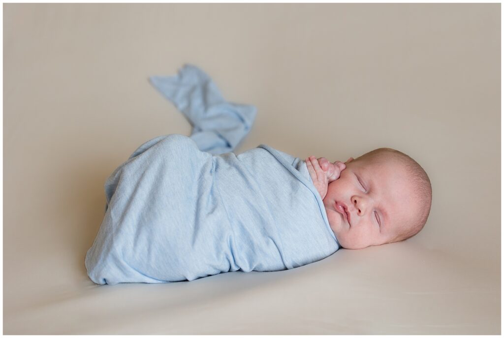 newborn baby wrapped in blue