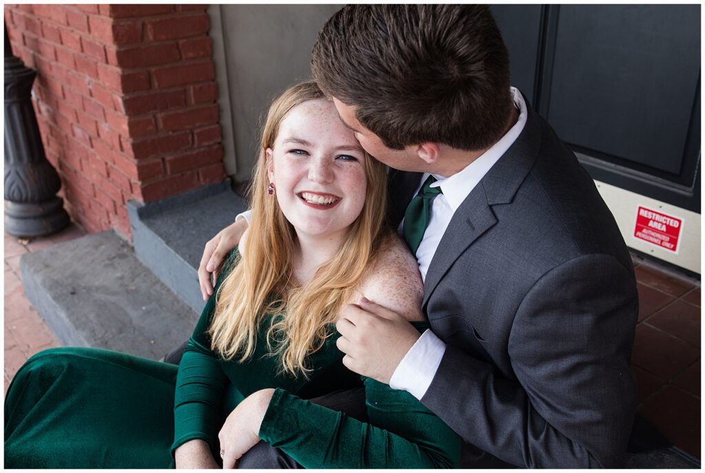 guy kissing girl on forehead