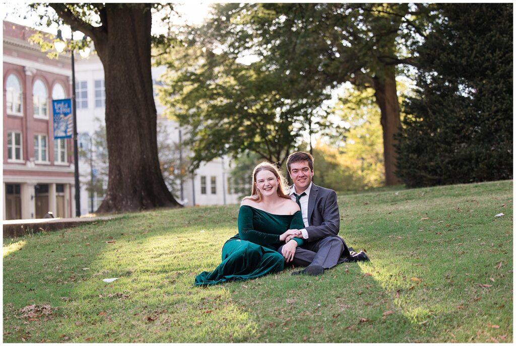 couple sitting on the grass in the sun