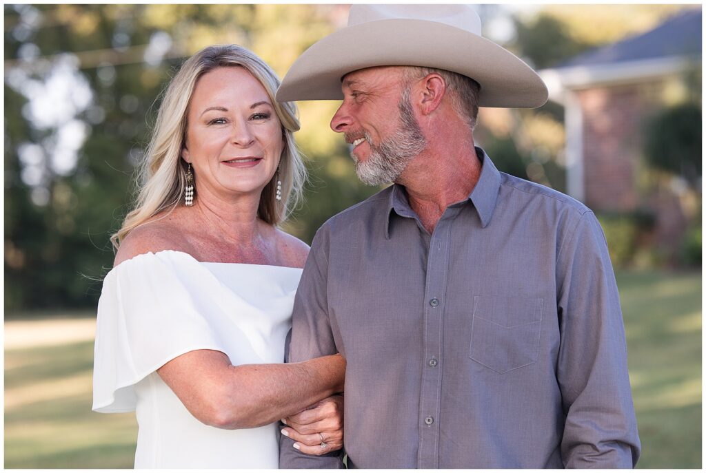 Engaged couple white dress cowboy hat