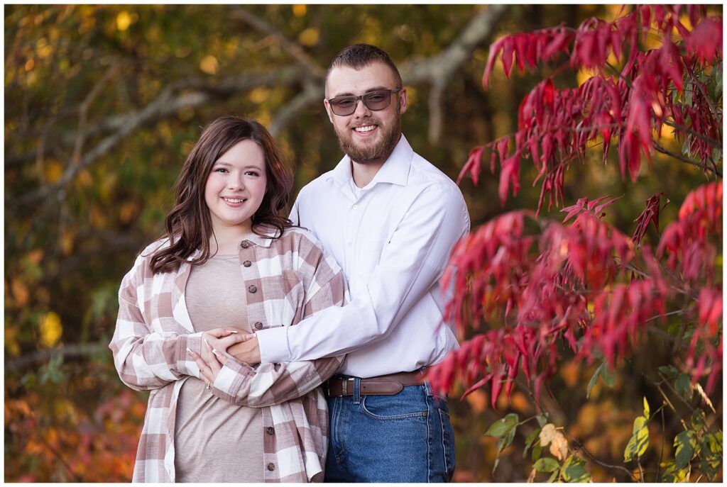 Couple by red tree at park