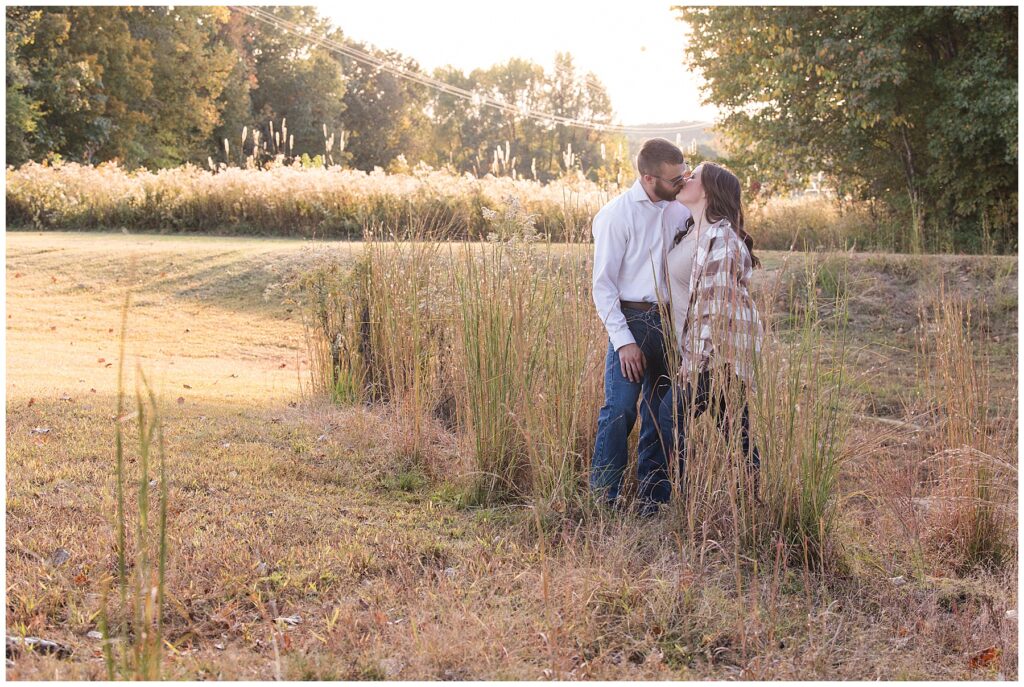 Couple kissing in the field at Pugh Bourne park