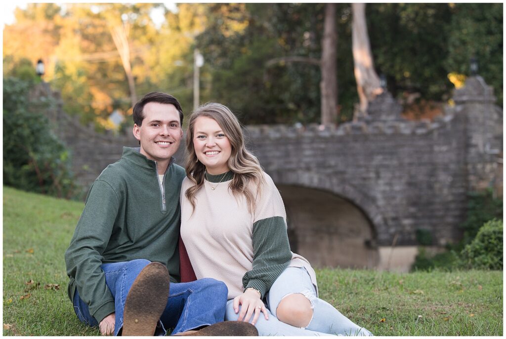 Savannah and Tyler pose in front of a stone bridge during their engagement session